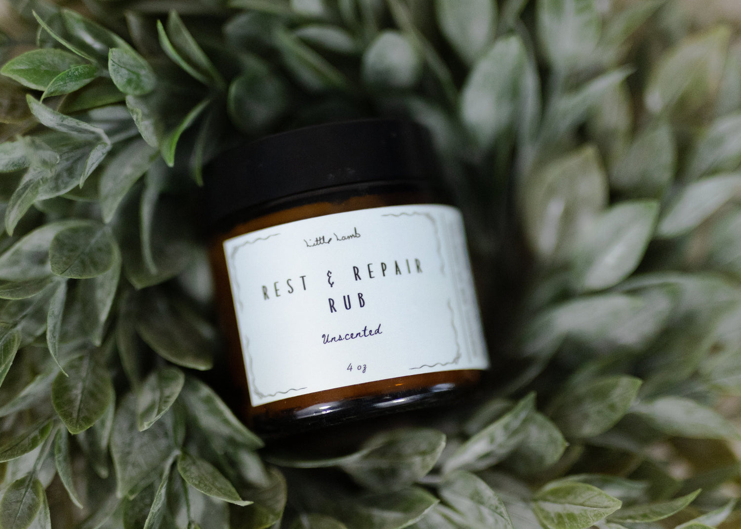 Bottle of 'Best C Repair Rub' surrounded by green leaves