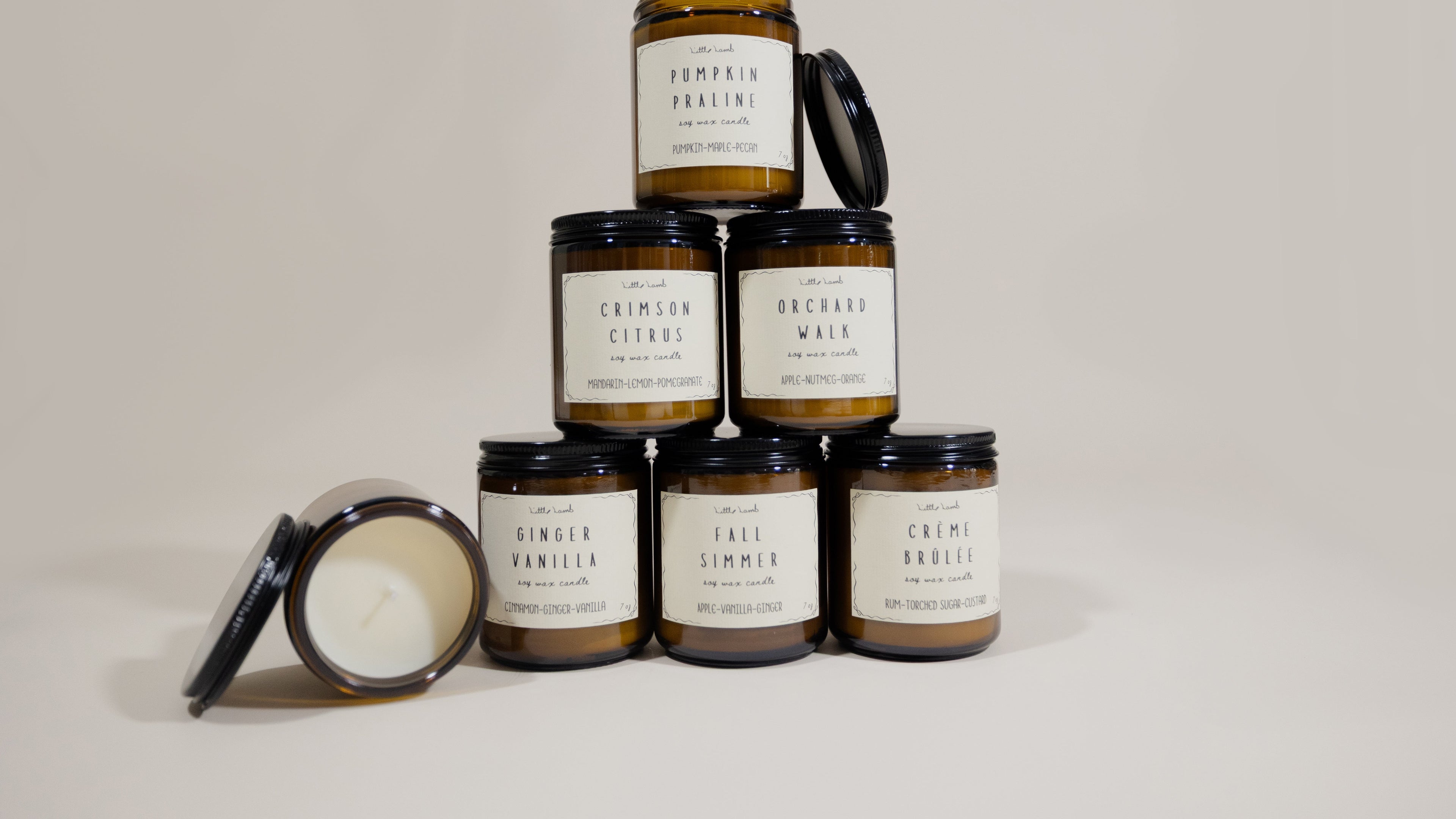 Collection of candles with labels on a neutral background