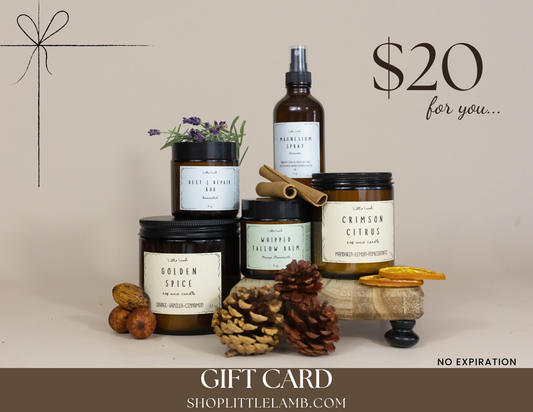 Collection of candles and a bottle with decorative elements on a beige background, featuring a gift card offer.